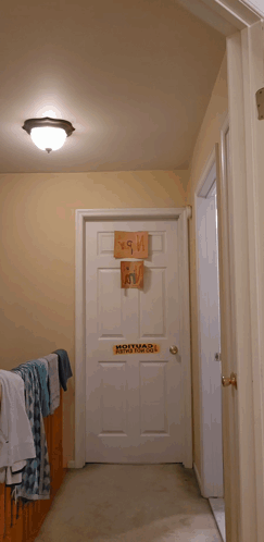 Man Standing In Front Of Bad Boy Door Sign GIF