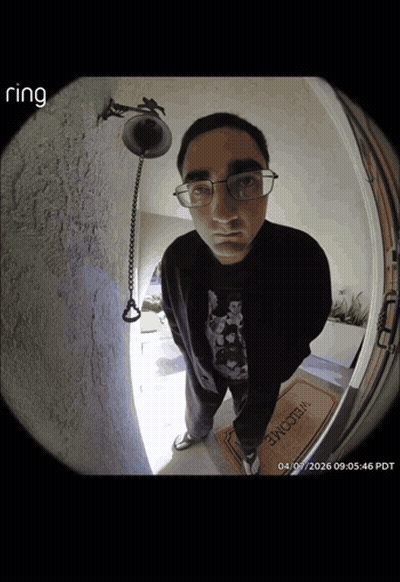 A Man Standing In Front Of A Door With A Welcome Mat GIF