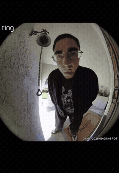 A Man Standing In Front Of A Door With A Welcome Mat GIF