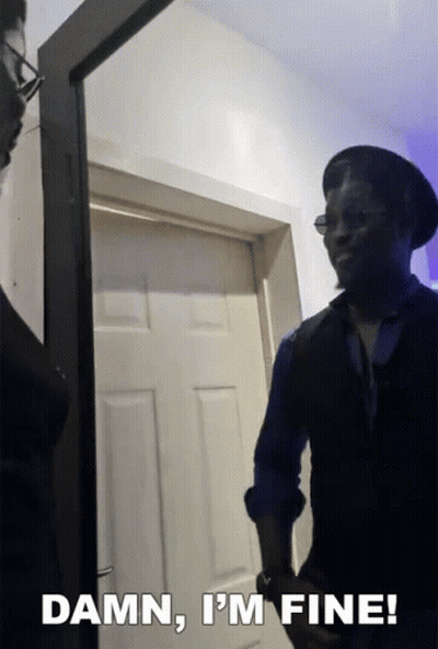 A Man Standing In Front Of A Door With The Words " Damn I 'M Fine " Above Him GIF