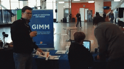 A Man Standing In Front Of A Gimm Sign GIF