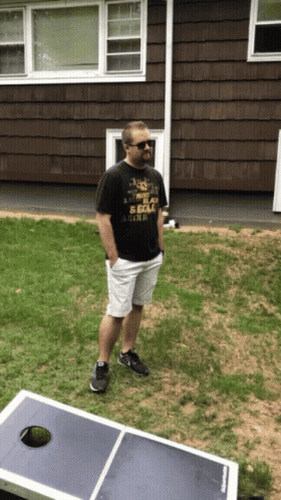 A Man Standing In Front Of A House Wearing A T-Shirt That Says " I 'M A Scout " GIF