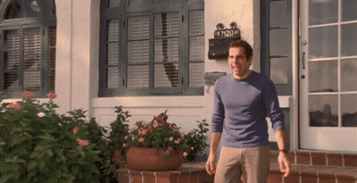 A Man Standing In Front Of A House With A Mailbox That Says 7120 GIF
