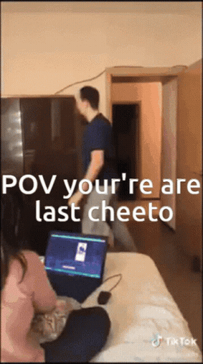 A Man Standing In Front Of A Laptop That Says Pov Your 'Re Are Last Cheeto On It GIF