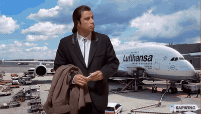 A Man Standing In Front Of A Lufthansa Plane GIF