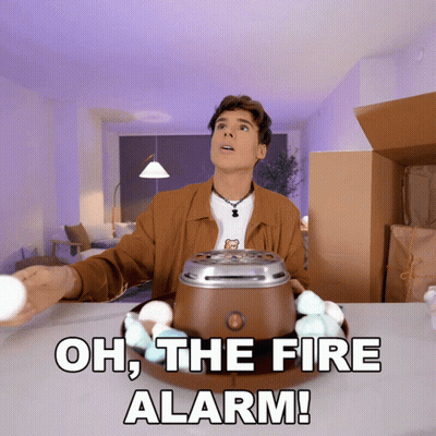 A Man Standing In Front Of A Marshmallow Maker With The Words Oh The Fire Alarm Written Below Him GIF