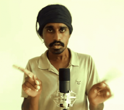 A Man Standing In Front Of A Microphone Wearing A Headband And A Shirt That Says ' Eagle ' On It GIF