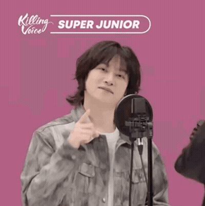 A Man Standing In Front Of A Microphone With Killing Voice Super Junior Written On It GIF