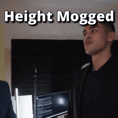 A Man Standing In Front Of A Microphone With The Words " Height Mogged " Above Him GIF