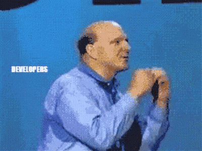 A Man Standing In Front Of A Microsoft Windows Developers Sign GIF