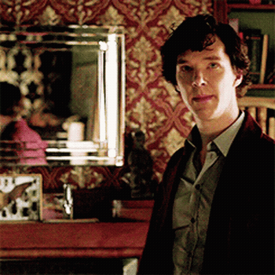 A Man Standing In Front Of A Mirror With A Clock On It GIF