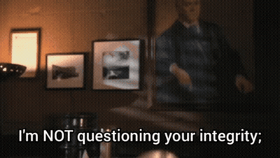 A Man Standing In Front Of A Mirror With The Words " I 'M Not Questioning Your Integrity " Below Him GIF