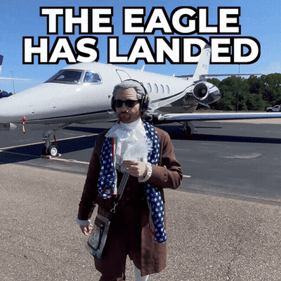 A Man Standing In Front Of A Plane That Says The Eagle Has Landed On It GIF