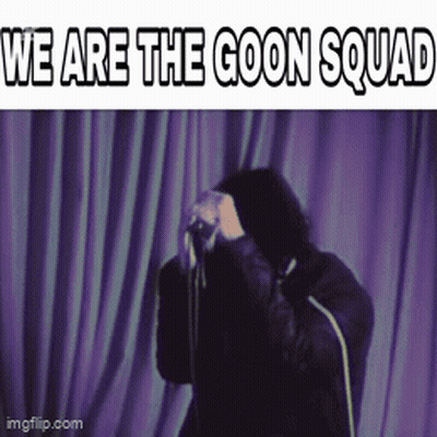 A Man Standing In Front Of A Purple Curtain With The Words " We Are The Goon Squad " GIF