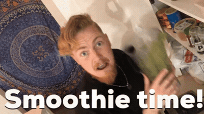 A Man Standing In Front Of A Shelf With The Words Smoothie Time Written Below Him GIF
