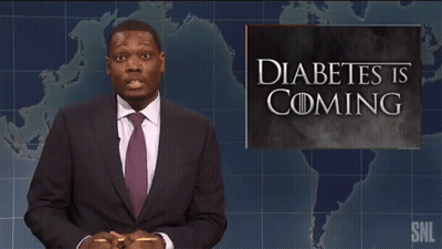 A Man Standing In Front Of A Sign That Says Diabetes Is Coming GIF