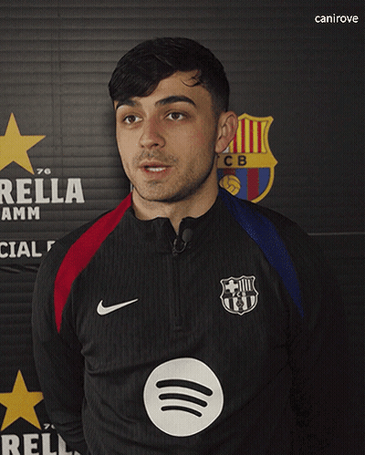 A Man Standing In Front Of A Sign That Says Rella Amm GIF