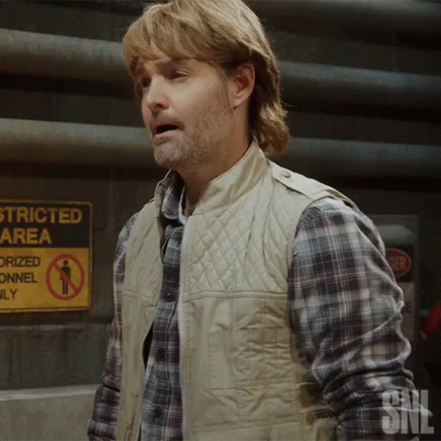A Man Standing In Front Of A Sign That Says Stricted Area GIF