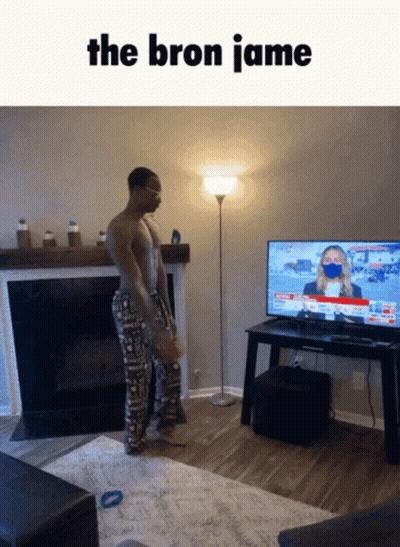 A Man Standing In Front Of A Television With The Words The Bron Jamie On The Bottom GIF