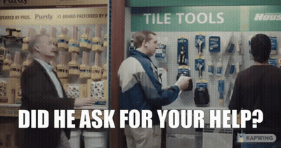 A Man Standing In Front Of A Tile Tools Display Asks For Help GIF