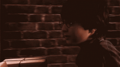 A Man Standing In Front Of A Train With The Words Back To Hogwarts Written On The Bottom GIF