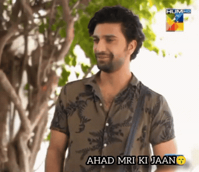A Man Standing In Front Of A Tree With The Words ' Ahad Mri Ki Jaan ' Below Him GIF