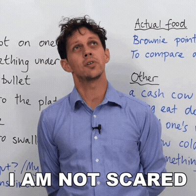 A Man Standing In Front Of A White Board With The Words I Am Not Scared GIF