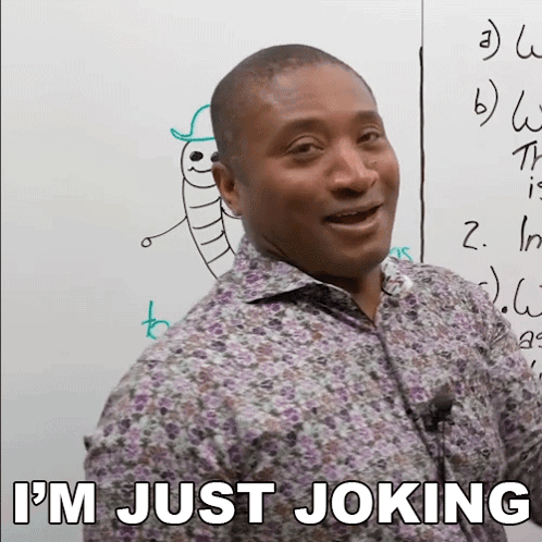 A Man Standing In Front Of A White Board With The Words I 'M Just Joking Below Him GIF