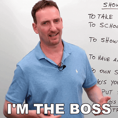 A Man Standing In Front Of A White Board With The Words I 'M The Boss Written On It GIF