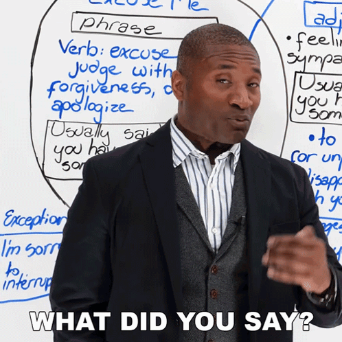 A Man Standing In Front Of A White Board With The Words " What Did You Say " Written On It GIF
