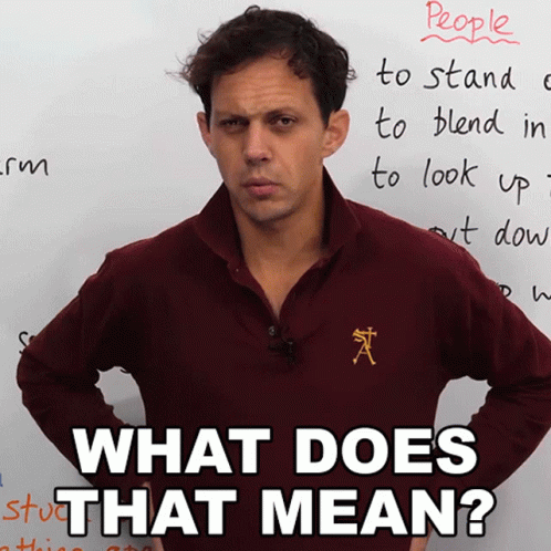 A Man Standing In Front Of A White Board With The Words " What Does That Mean " Written On It GIF