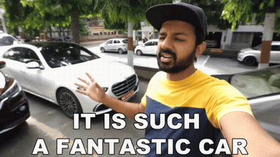 A Man Standing In Front Of A White Car With The Words " It Is Such A Fantastic Car " Below Him GIF
