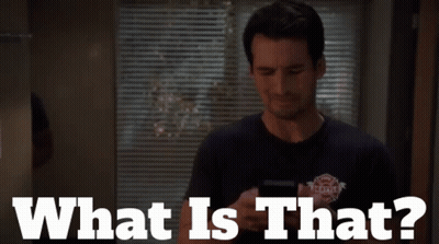 A Man Standing In Front Of A Window With Blinds And The Words What Is That On The Bottom GIF
