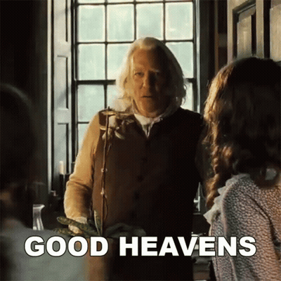 A Man Standing In Front Of A Window With The Words Good Heavens Written On The Bottom GIF