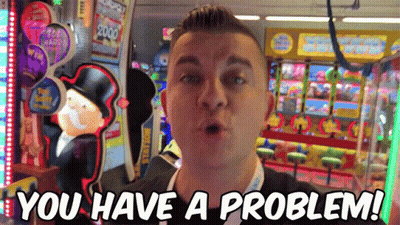 A Man Standing In Front Of An Arcade Machine With The Words " You Have A Problem " On The Bottom GIF
