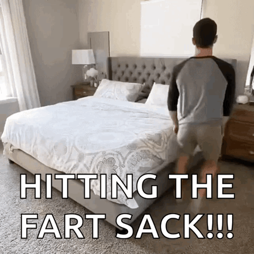 A Man Standing Next To A Bed With The Words Hitting The Fart Sack GIF