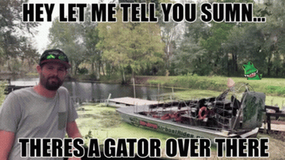 A Man Standing Next To A Boat That Says Airboat Rides On The Side GIF