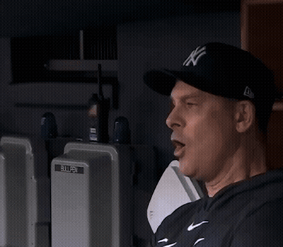 A Man Standing Next To A Bullpen Box GIF