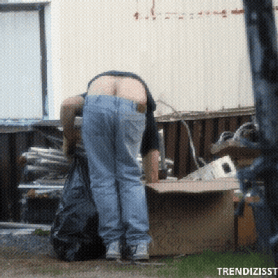 A Man Standing Next To A Cardboard Box That Says ' Recycling ' GIF