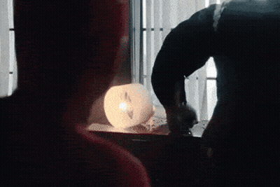 A Man Standing Next To A Giant Monster In A Room GIF
