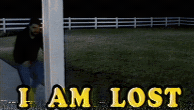 A Man Standing Next To A Pole With The Words I Am Lost In Yellow Letters GIF