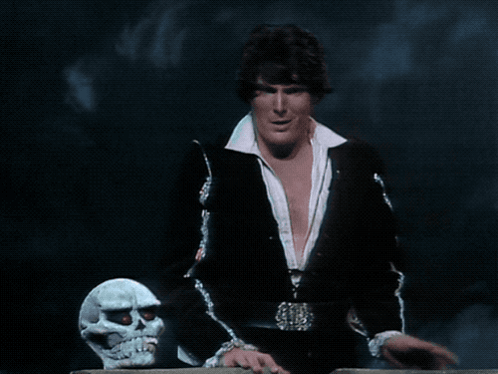 A Man Standing Next To A Skull With The Words Hamlet Does N't Sing GIF