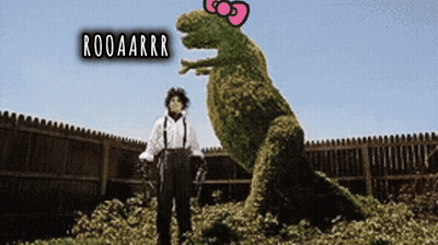 A Man Standing Next To A T-Rex With The Words Rooaarrr On The Top GIF