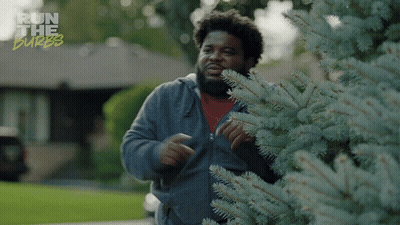 A Man Standing Next To A Tree With The Words Run The Burbs Written On The Bottom GIF