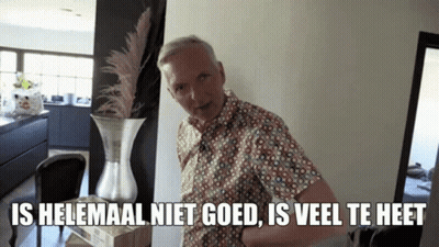 A Man Standing Next To A Vase With The Words Is Helemaal Niet Goed Is Veel Te Heet Written Below Him GIF