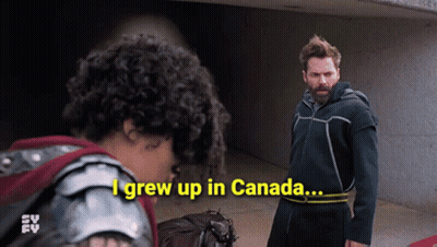 A Man Standing Next To A Woman With The Words I Grew Up In Canada GIF