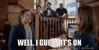 A Man Standing Next To A Woman With The Words Well I Guess It 'S On On The Bottom GIF