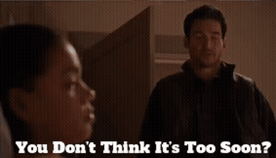 A Man Standing Next To A Woman With The Words " You Don 'T Think It 'S Too Soon " On The Bottom GIF