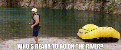 A Man Standing Next To A Yellow Raft With The Words Who 'S Ready To Go On The River GIF