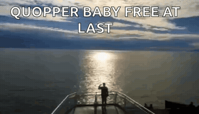 A Man Standing On A Balcony Overlooking A Body Of Water With The Words Quopper Baby Free At Last Above Him GIF